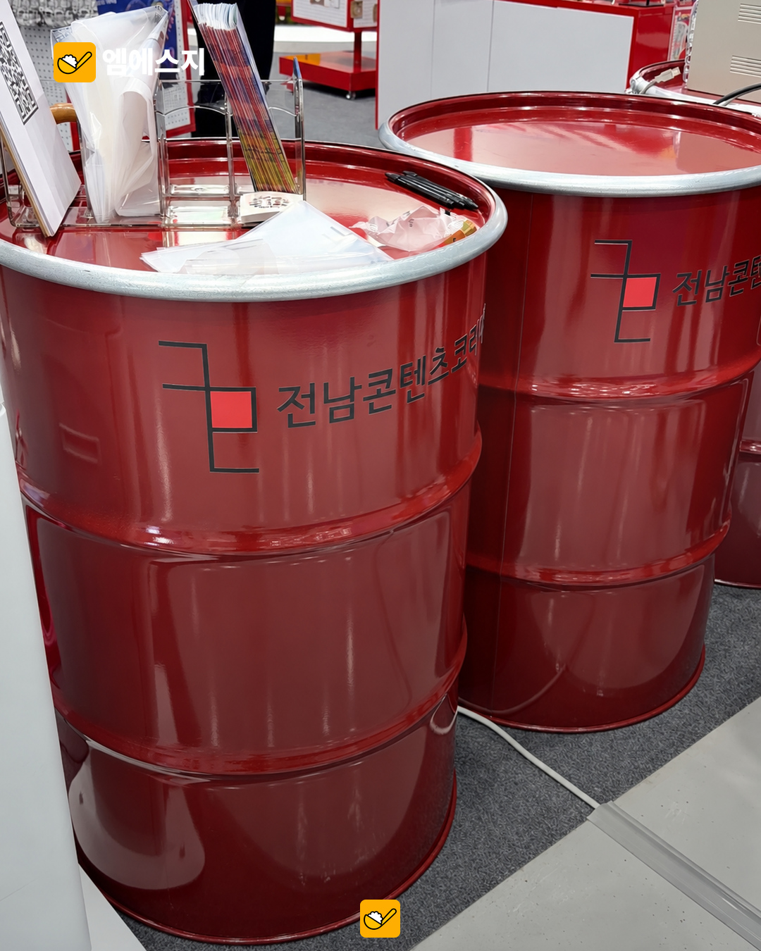 실내 전시 테이블로 활용한 빨간 드럼통.